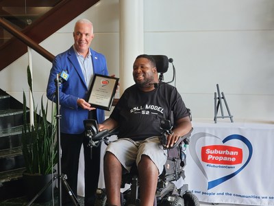Michael Stivala (L), CEO of Suburban Propane, presents the 2021 SuburbanCares award to Eric LeGrand.